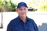 A man in a blue shirt and hat.