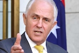 Malcolm Turnbull gestures as he speaks at an outdoor podium at Parliament House in Canberra.