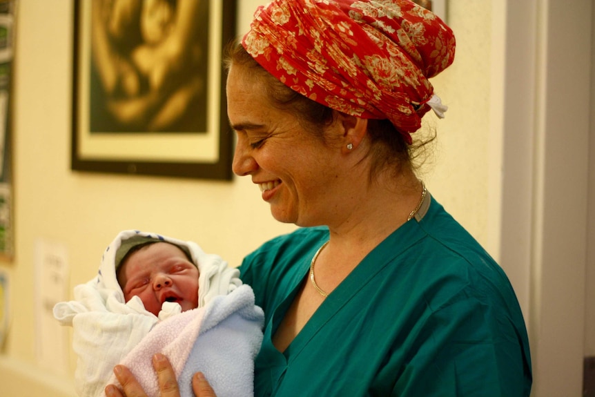 It's a girl! Midwife Daphna Strassberg holds a baby she just helped deliver at the Hadassah Ein Kerem hospital in Jerusalem.