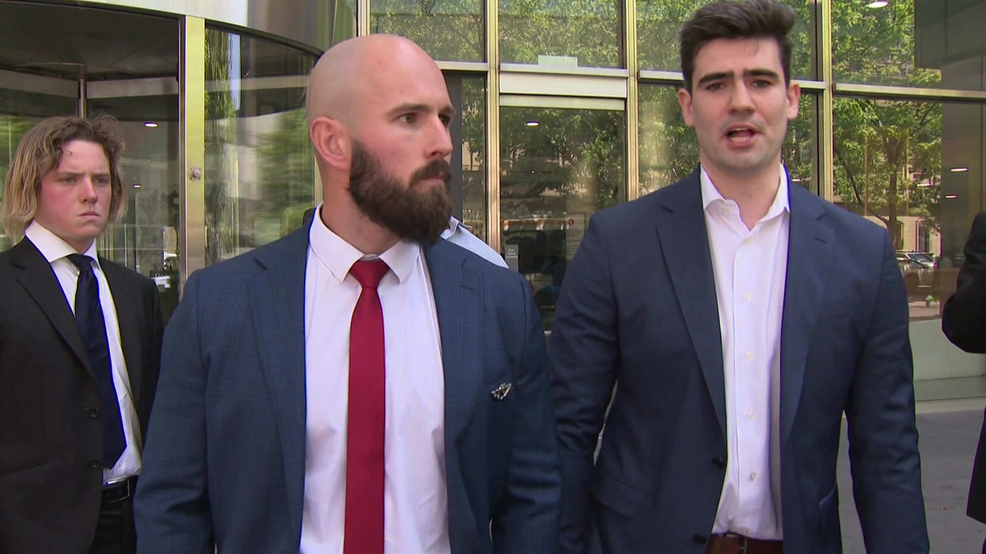 Two men wearing suits standing outside a Melbourne court