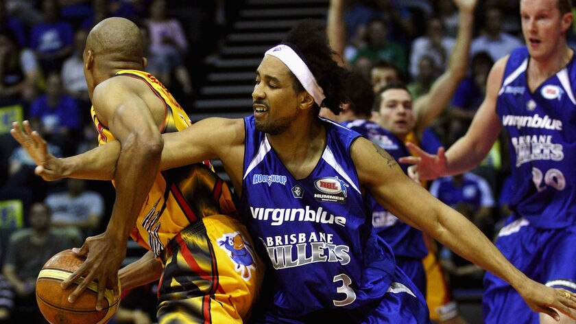 Darryl McDonald of the Tigers is pressured by CJ Bruton of the Brisbane Bullets on February 28, 2008