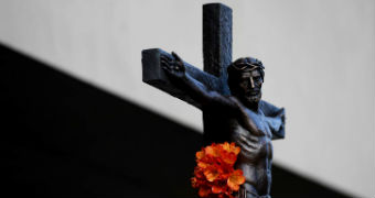 Stock images of a crucifix with flowers placed on it in Melbourne.
