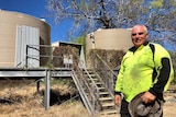 Image of Darlngunaya resident Bundy Aksenov with the remote community's current water infrastructure.