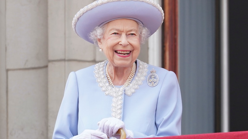 Queen Elizabeth II smiles as she watches from the balcony of Buckingham Palace 