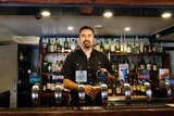 Co-owner Ben Johnston pours a beer at the Old Canberra Inn.