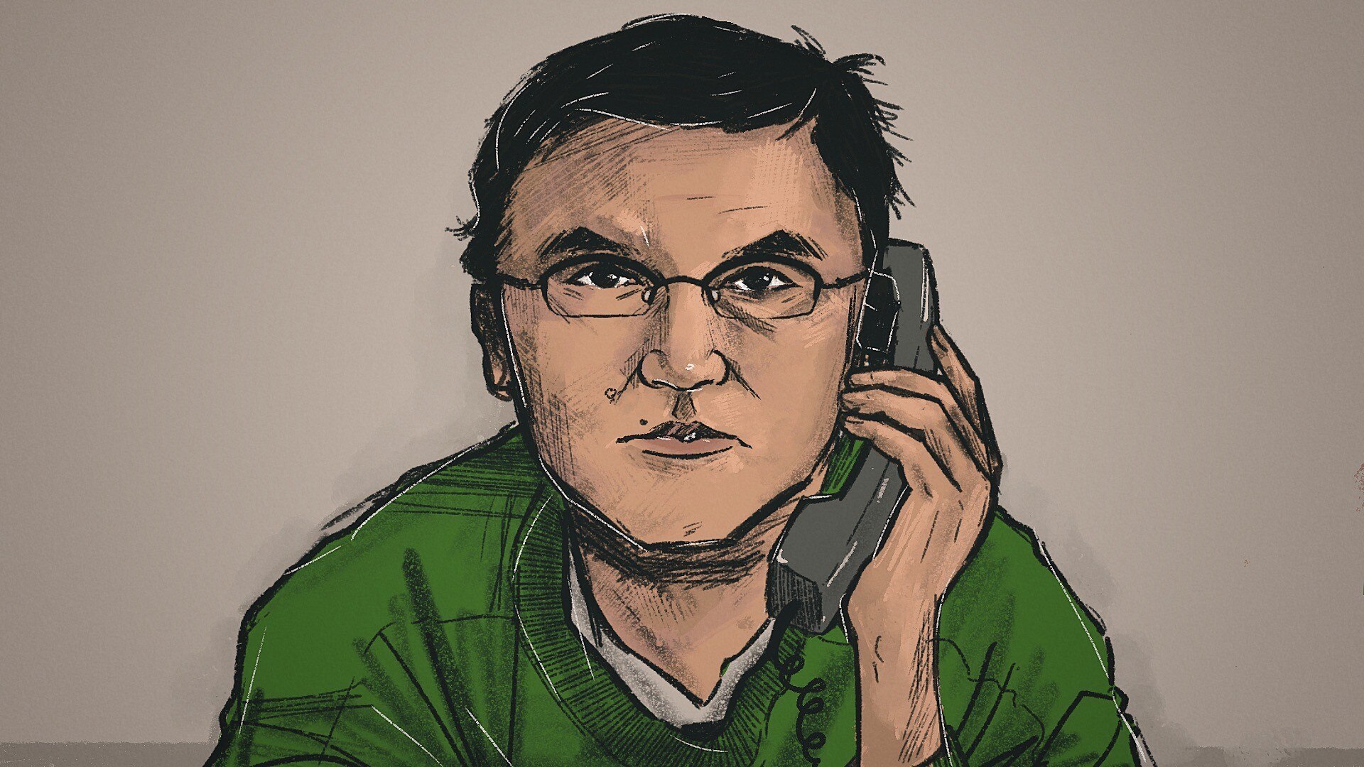 Frank Hu holds a phone to his ear, dressed in a green jumper.