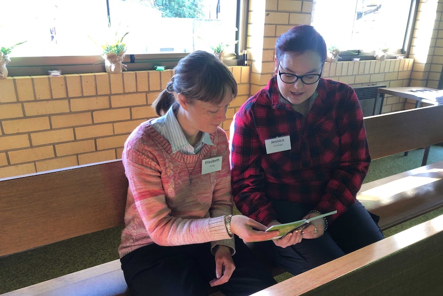 Two woman sitting in church