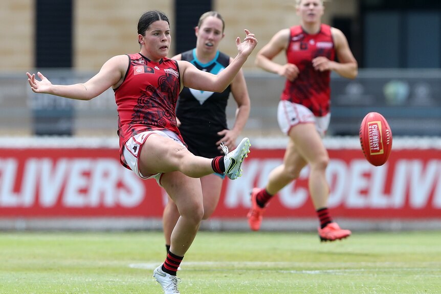 Madison Prespakis kicks the ball while a Port Adelaide player gives chase