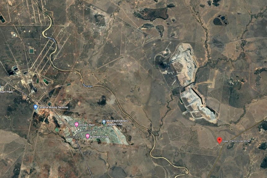 a satellite view of the proximity of a coal mine to a town