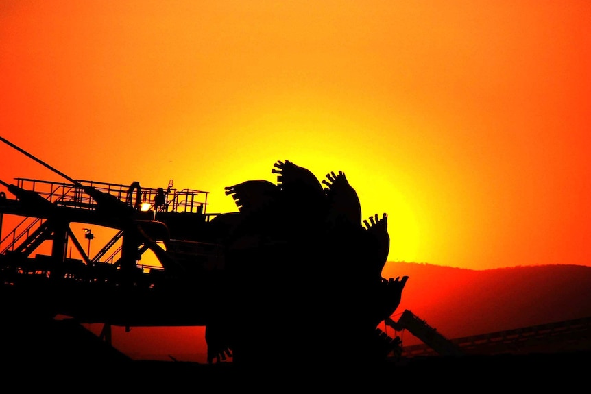 A silhouette of mining equipment