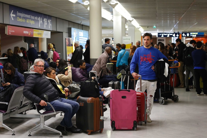 Passengers wait at Orly airport near Paris