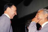 Paul Keating and Bob Hawke face each other laughing enthusiastically.