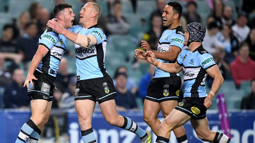 Cronulla's Chad Townsend (L) celebrates his try with teammates against Penrith in NRL semi-final.