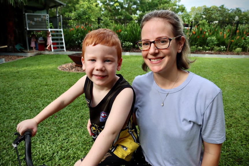 Elizabeth Adamson and her son Jake in their backyard in Darwin. 