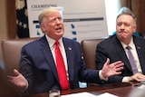 Donald Trump gesticulating while Mike Pompeo watches on