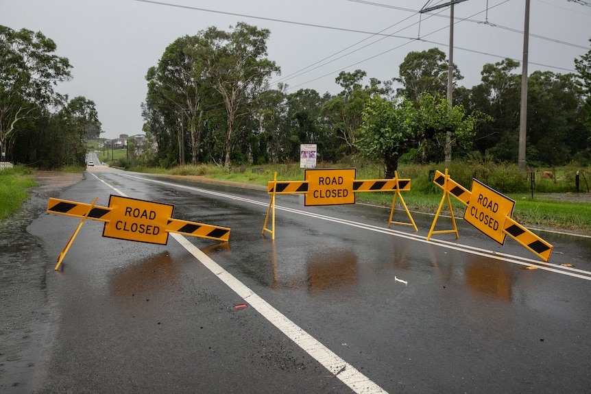 A road with signs on it that says road closed