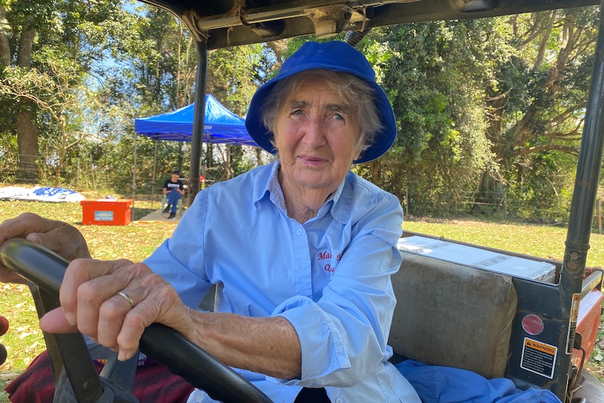 A woman on a buggy with a blue shirt