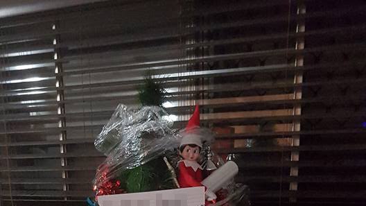 A Christmas tree wrapped in plastic with a note attached to it