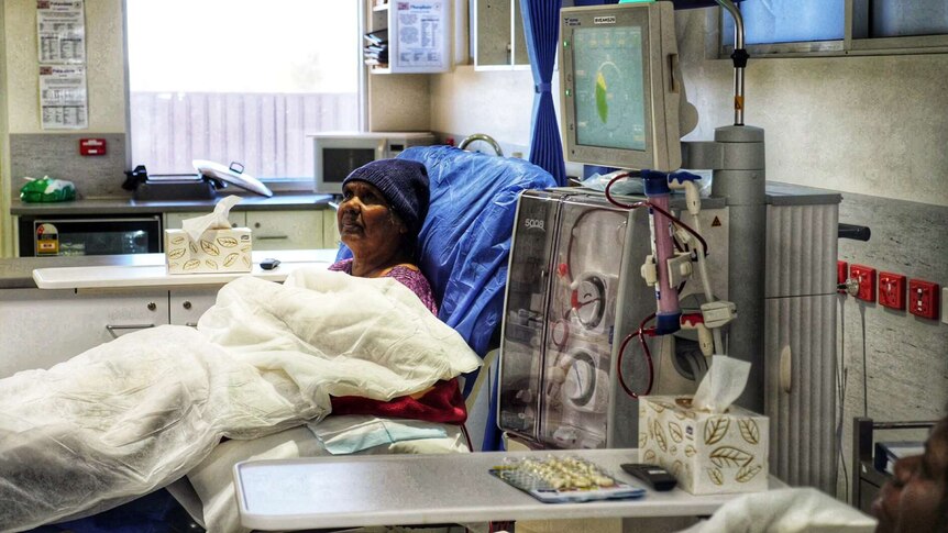 Mavis Holmes sits in a chair undergoing dialysis treatment.