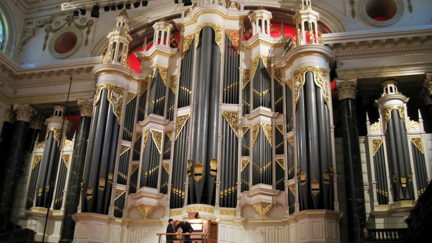 A large pipe organ, gilded with gold