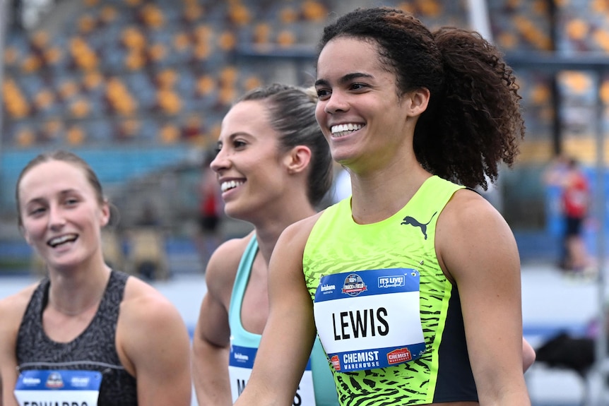 An Australian female sprinter celebrates winning the national 100m title.