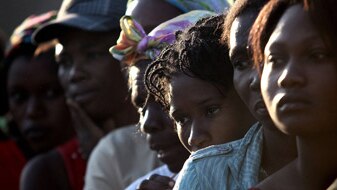 Women line up to receive sacks of rice in Port-au-Prince, February 9, 2010 (Getty Images: John Moore)