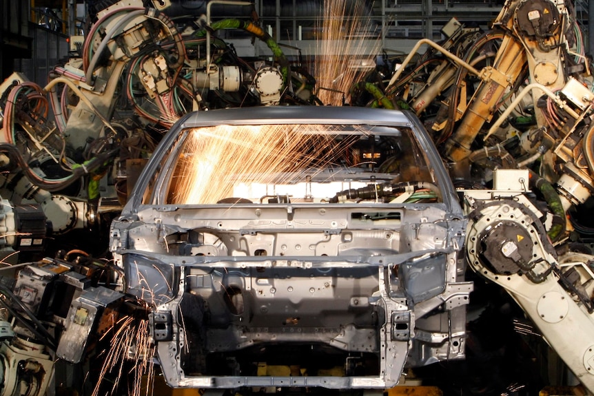 Robots work on a body shell of a Toyota Camry Hybrid car at the Toyota plant in Altona.