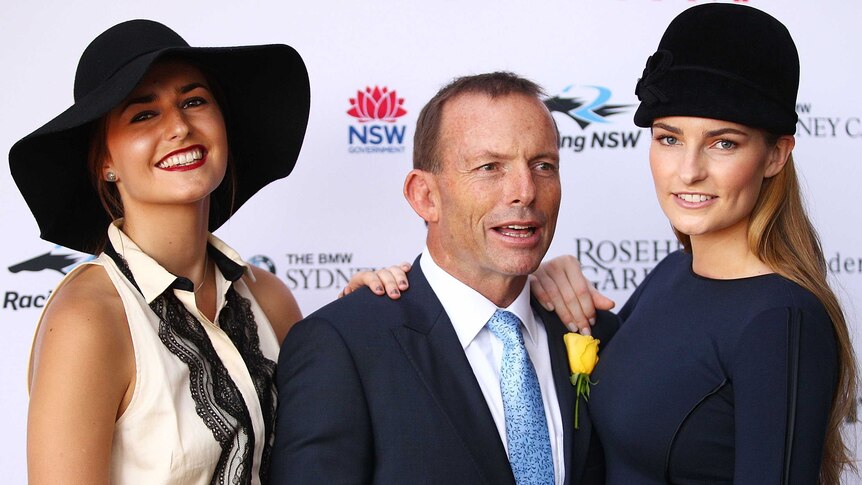 Tony Abbott poses with daughters Bridget and Frances during 2012 Golden Slipper Day.