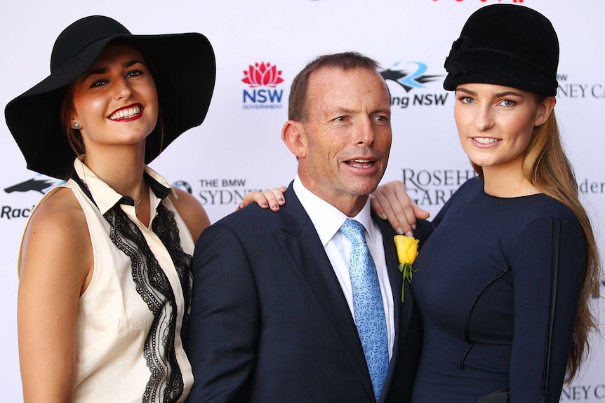 Tony Abbott poses with daughters Bridget and Frances during 2012 Golden Slipper Day.