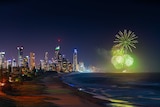 night time picture of surfers paradise skyline and beachline with fireworks over the ocean