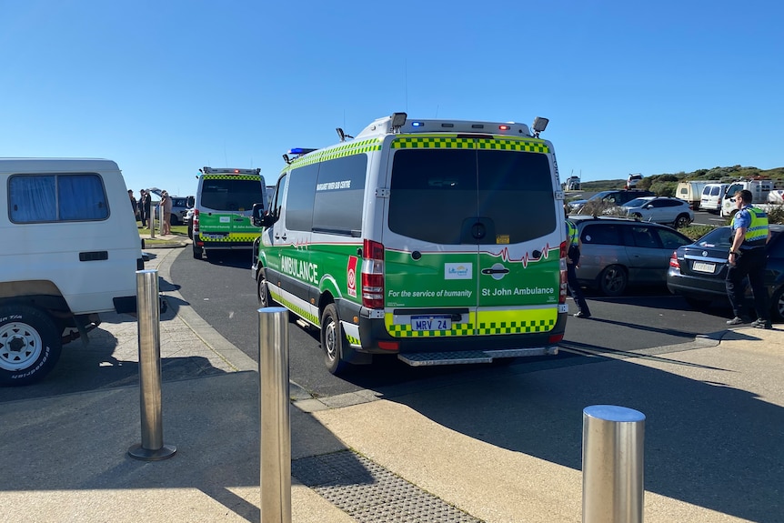 Two ambulances parked at a beach.