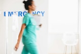 Nurse walks through hospital emergency department.