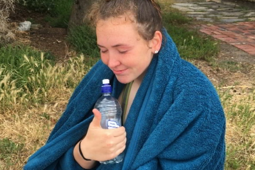 Sarah Williams sits with a towel around her shoulders.