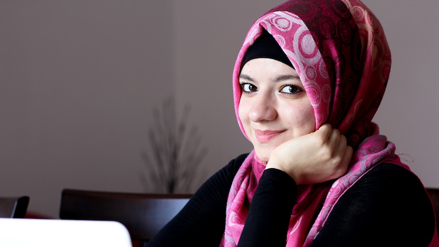 Nadine Ettash sits at her dining table with laptop open.