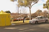 Police and emergency personnel attend a murder at a Red Hill house a house on Mugga Way, Canberra on July 23, 2012.