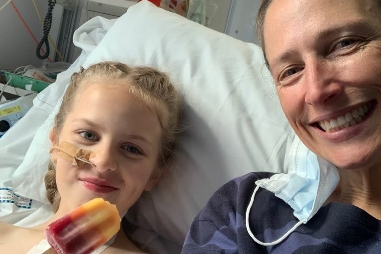 A woman and her daughter in a hospital bed