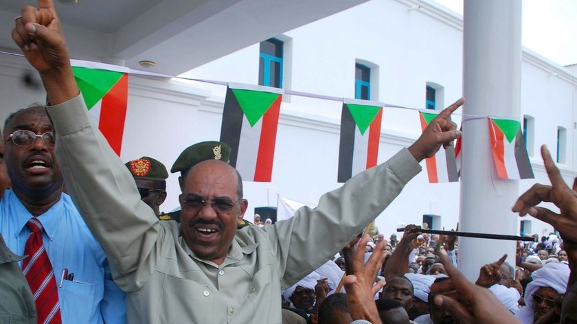 Sudanese President Omar Hassan al-Bashir greets his supporters during a protest rally