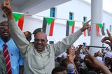 Sudanese President Omar Hassan al-Bashir greets his supporters during a protest rally