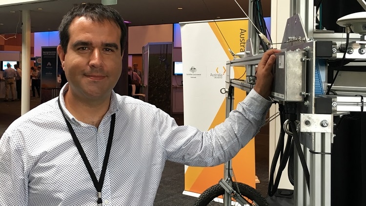 CSIRO researcher Dr Jose Jiminez-Berni with the Phenomobile, a 2m high machine fitted with lidar radar cameras.
