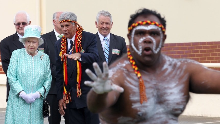 Queen Elizabeth watches an Aboriginal dancer on her final visit to Australia.