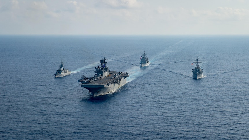 U.S. Navy and Royal Australian Navy ships make their way through the South China Sea