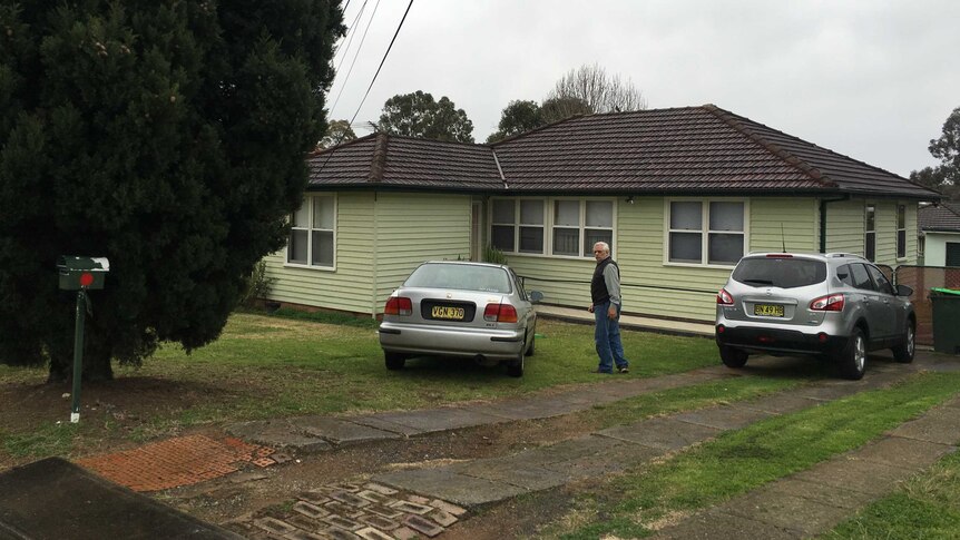 An unidentified man arrives at a house that was raided by counter-terrorism police today.