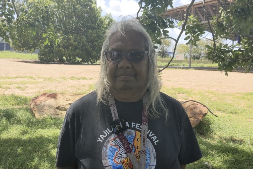 An Indigenous Australian woman wearing a black t-shirt. 
