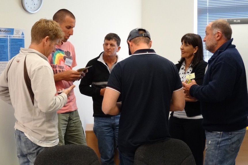 A group of people standing in a circle talking