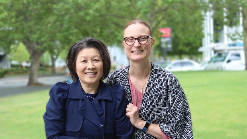 Professor Arlene Chan and Adele Given pose in front of trees