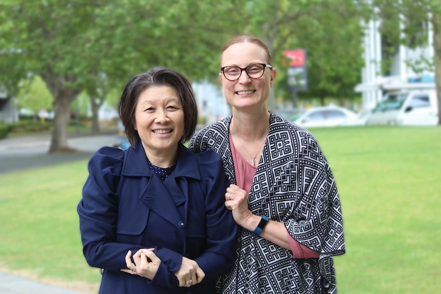 Professor Arlene Chan and Adele Given pose in front of trees