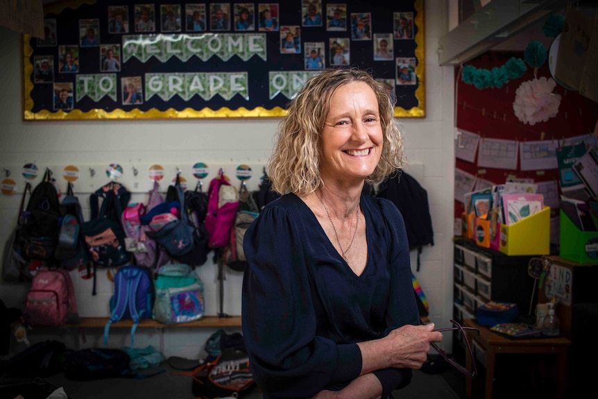 A woman sits in a classroom