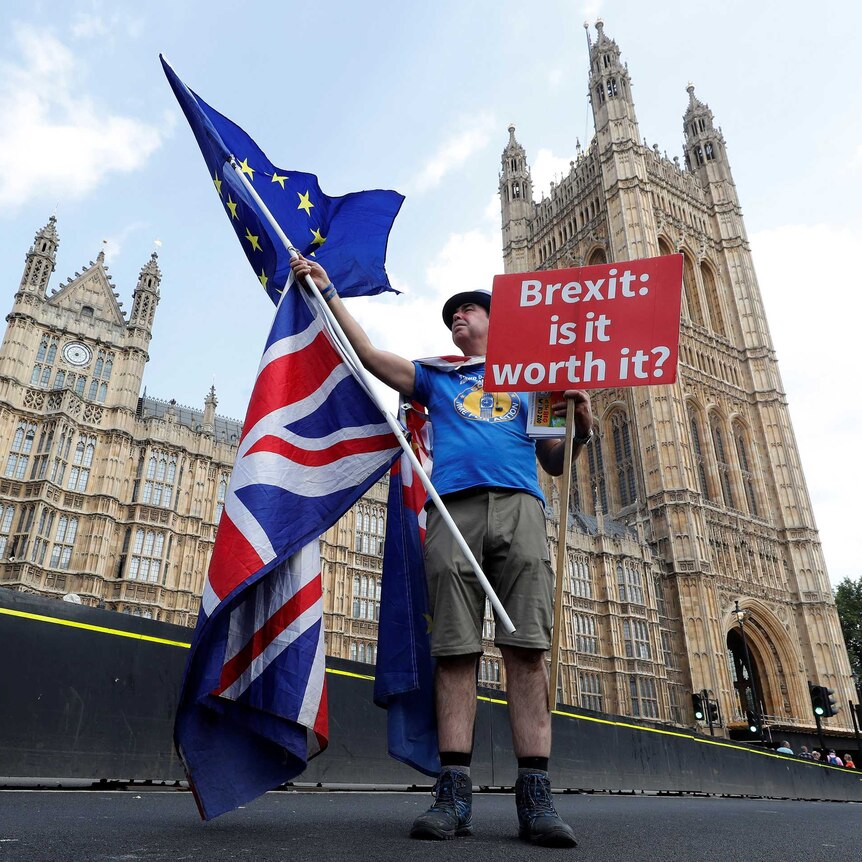 A man holds an anti-Brexit sign near the Big Ben