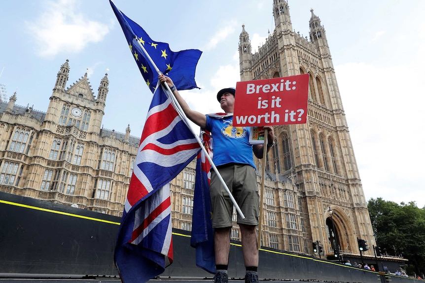 A man holds an anti-Brexit sign near the Big Ben