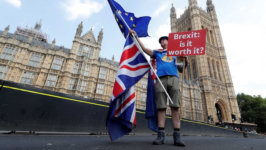 A man holds an anti-Brexit sign near the Big Ben